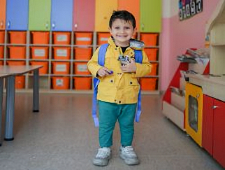 a young boy standing in front of a colorful wall photo a young boy standing in front of a colorful wall photo